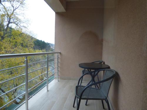 a balcony with a table and chairs on it at Rivera Raška in Raška