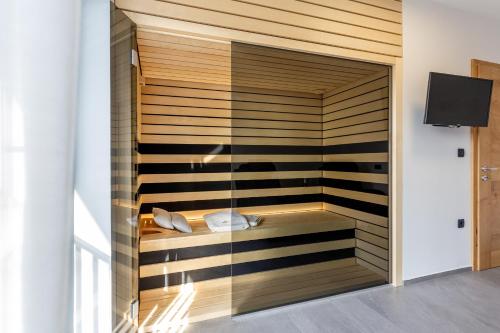 a room with a sauna with a glass wall at Hiša Urma in Celje