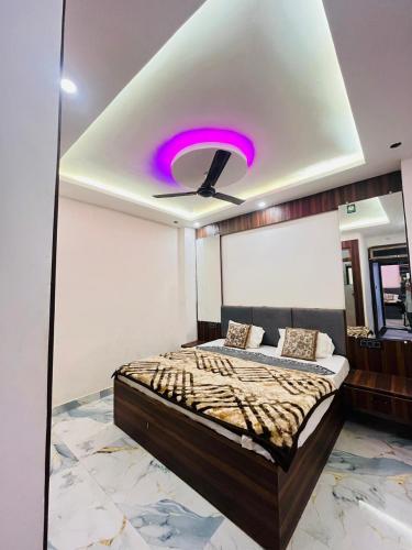 a bedroom with a bed with a purple ceiling at Hotel Kaushalya in Ayodhya