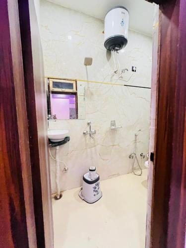 a bathroom with a sink and a toilet in it at Hotel Kaushalya in Ayodhya