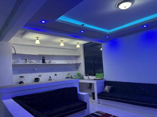 a room with two benches and a blue lighting at Panorama Housing Complex in Addis Ababa