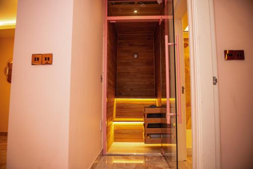 an empty room with a wooden staircase in a house at Velmora Apartments in Huddersfield