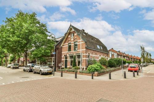 a large brick building on a street with cars parked at B&B De Duinhoek in Beverwijk