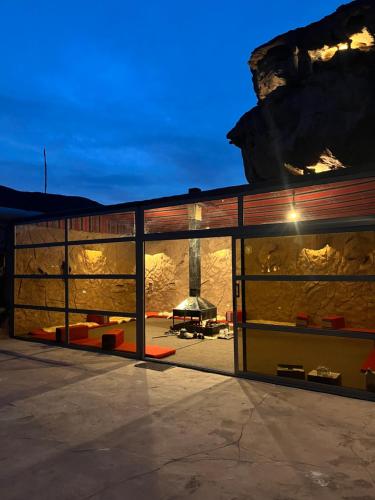 a large building with ajar doors with a fireplace at Adel Wadi Rum Camp Bubble in Disah