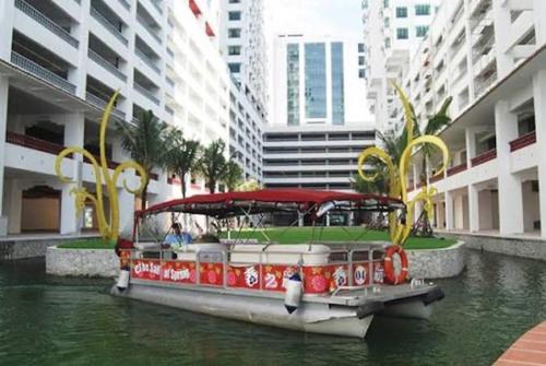 a boat on a river in a city at Heritage cando in Seri Kembangan