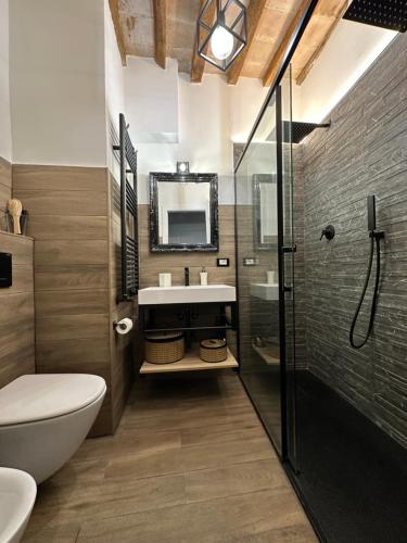 a bathroom with a sink and a toilet and a mirror at Residenza la Mandorla in Perugia