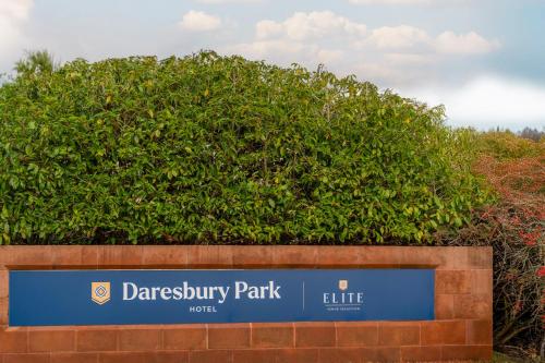 a sign for a park in front of a bush at Daresbury Park Hotel in Daresbury