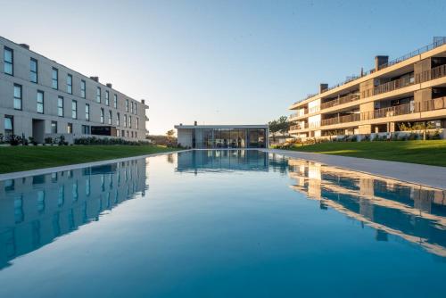 a pool of water in front of a building at Apartment in Apúlia - Magno House in Apúlia
