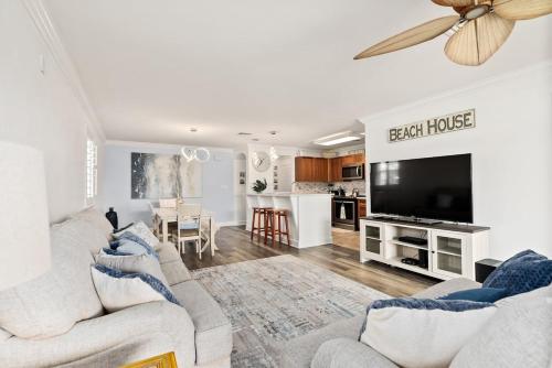 a living room with two couches and a flat screen tv at Island Paradise Resort Villa in Honokai Hale