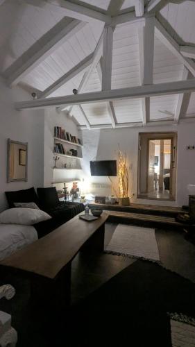a living room with a couch and a table at Αγροτικό σπίτι agrikia με θέα στο βουνό πάρκινγκ και δωρεάν WiFi in Arachova