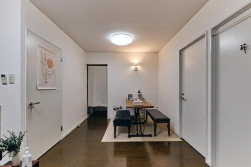 a hallway with a table and chairs in a room at HigashiNakano 3 rooms 1 bath with 2 different view in Tokyo