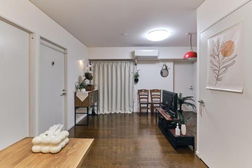 a living room with a couch and a table at HigashiNakano 3 rooms 1 bath with 2 different view in Tokyo