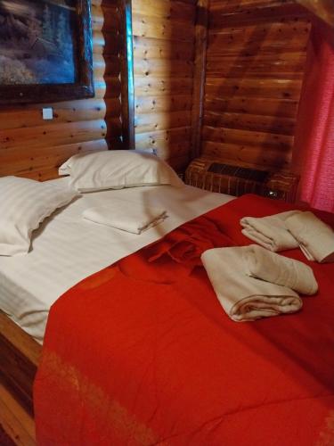 a large bed with white sheets and pillows on it at Chalet Zachlorou in Kalavrita