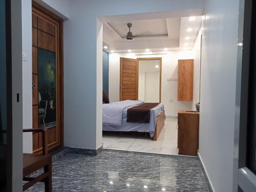 a bedroom with a bed and a mirror at KODIVEED Heritage in Alleppey