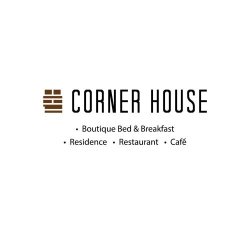 a logo for a corner housebuilder bed and breakfast at The Corner House in Pontian Kecil