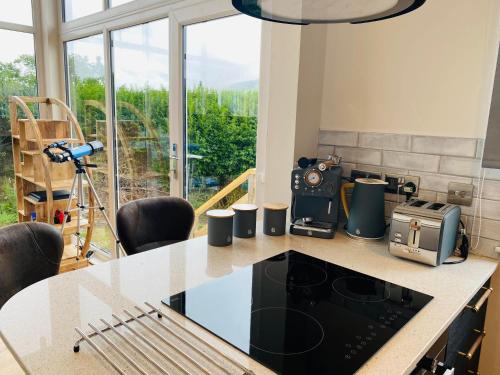 a kitchen with a table with a camera on it at Luxury Portree Cottage Hillside in Portree