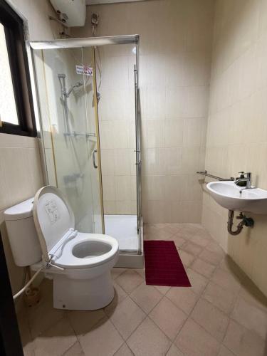 a bathroom with a shower and a toilet and a sink at Pandan de Bali in Ungasan