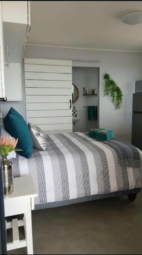 a bedroom with a large bed and a table at View on the Bay 7 Pinta Crescent in St. Helena Bay