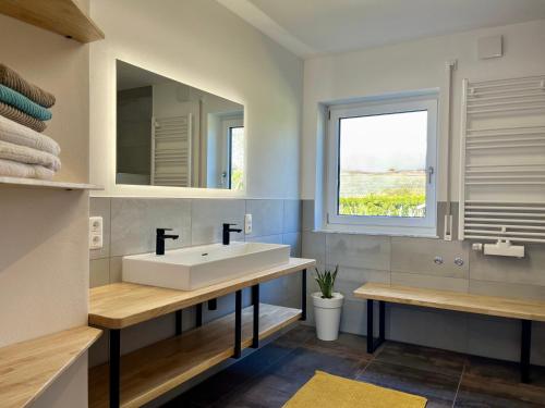 a bathroom with a sink and a window at Familienidylle im Altmühltal in Solnhofen