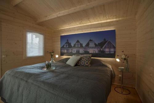 a bedroom with a bed in a wooden cabin at Studio long term stay in Makkum in Makkum