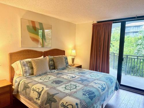 a bedroom with a bed and a balcony at Paradise Found Cayo Hueso in Key West