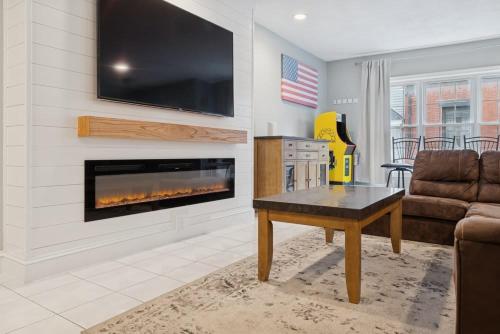 a living room with a couch and a fireplace at Heart of Southie - Hot Tub + Walk to Top Bars in Boston