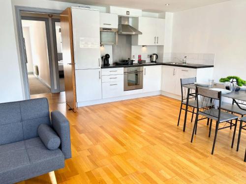 a kitchen and dining room with a table and a couch at York City Centre 2 Bed Flat with Views - Steps from Christmas Market in York