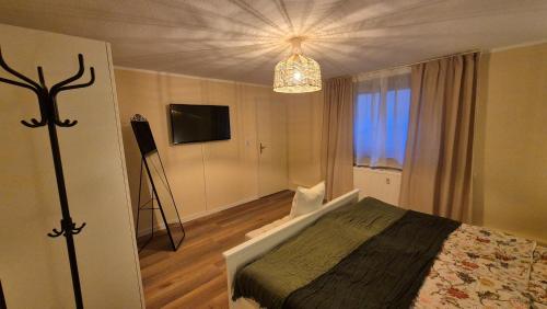 a bedroom with a bed and a chandelier at Apartement Victoria in Swisttal