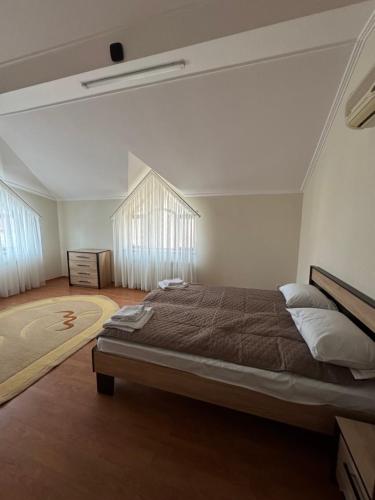 a bedroom with a large bed in a room at Будинок на Духновича in Mukacheve