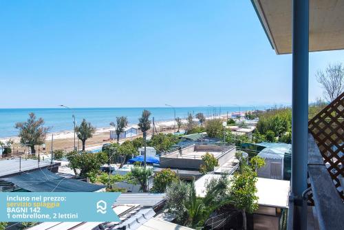 a view of the beach from the balcony of a condo at Appartamento a Senigallia sul mare - SE004 in Senigallia