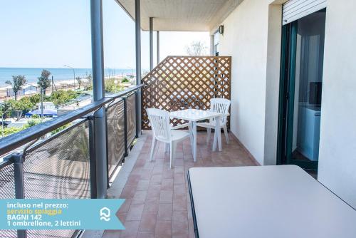 a balcony with a table and chairs and the ocean at Appartamento a Senigallia sul mare - SE004 in Senigallia