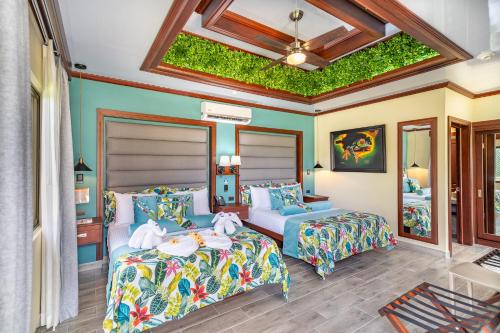 福尔图纳阿雷纳尔温泉度假村酒店的一间卧室，里面有两张床，天花板上装饰着植物。