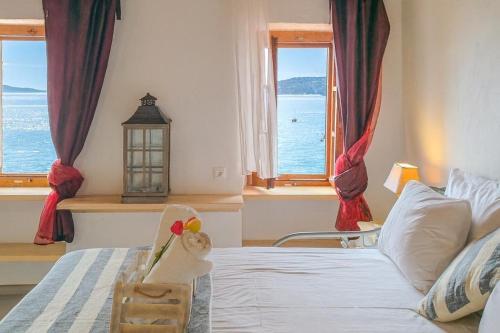 a bedroom with a bed with a view of the ocean at Sea Frame in Skiathos