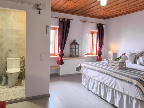 a bedroom with a large bed and windows at Sea Frame in Skiathos