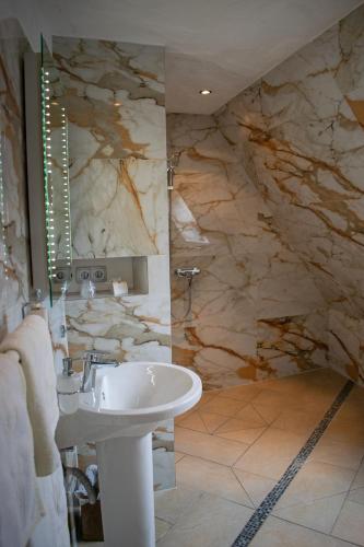 a bathroom with a sink and a shower at Hotel Karthäuser Hof in Flörsheim am Main