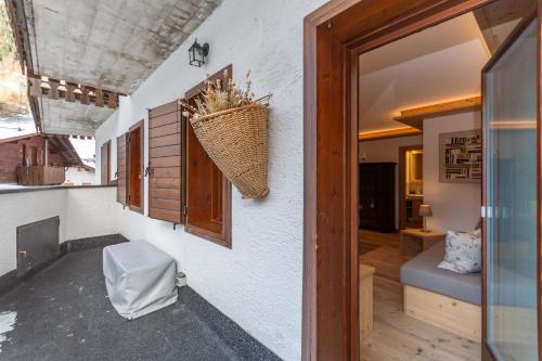 a room with a window and a door with a chair at Alpine Nest in Rocca Pietore