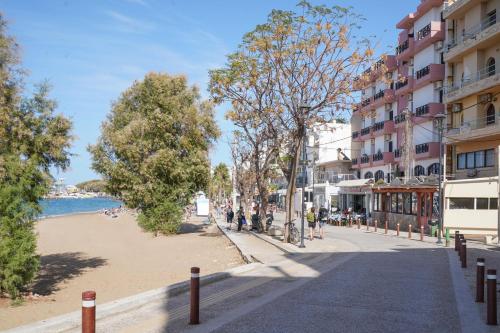 a street next to a beach with buildings at Posidonio Hotel in Chania