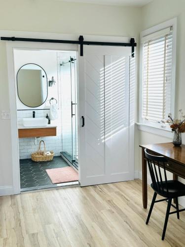 a bathroom with a glass door with a sink and a mirror at Garden Oasis 3BR 15 min FIFA World Cup MetLife Std in Harrison