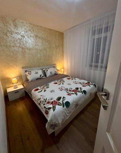 a bedroom with a bed with a floral bedspread at Signature Studio Arad in Arad