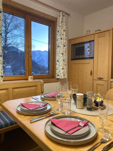 a dining room table with plates and napkins on it at Ferienhaus s'Mosern in Grundlsee