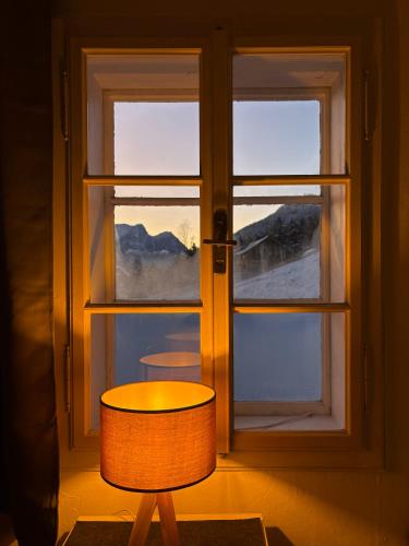 a lamp sitting in front of a window at Ferienhaus s'Mosern in Grundlsee