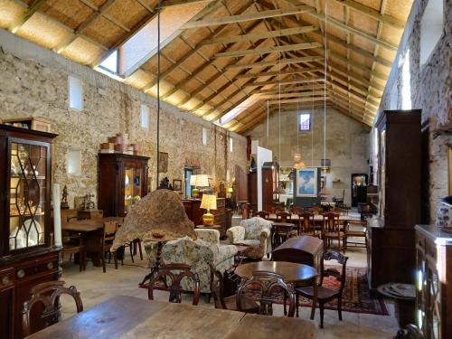 a large room with tables and chairs in a building at Jardim de Copas in Alcochete