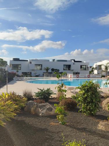 a resort with a swimming pool and a building at Casa Fuerte y Levamt in Villaverde