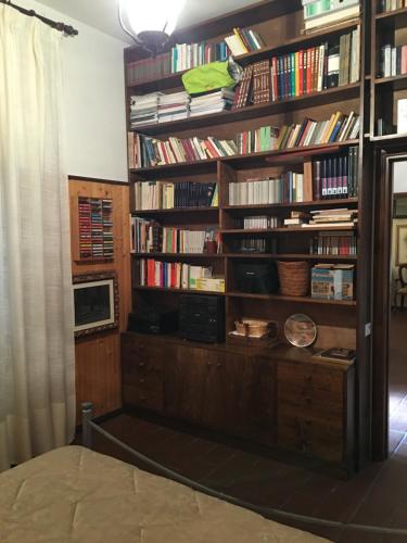 a room with a book shelf filled with books at Case Ballerini in Manciano