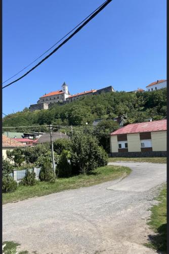 an empty street with a building on a hill at Family2 in Mukacheve