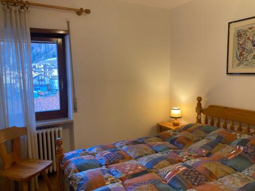 En eller flere senge i et værelse på Appartamento Casa Latemar