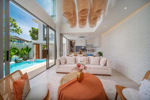 a living room with white furniture and a pool at 云栖别院 Cloudrest Villa in Phuket