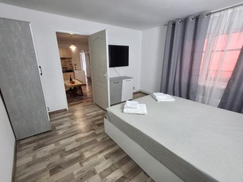 a bedroom with a bed and a television in it at Casa Stadion in Craiova
