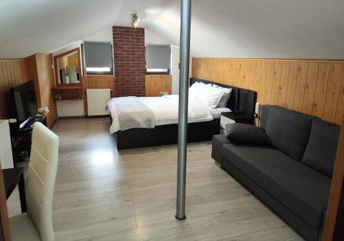 a hotel room with a bed and a couch at Casa Crissio in Sinaia