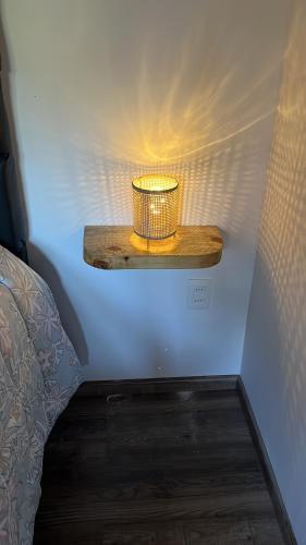 a small lamp on a shelf in a room at Punta Negra - Cabañas Cacarelhos in Piriápolis